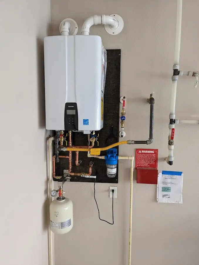 Professional plumber installing copper piping in a Rogers home